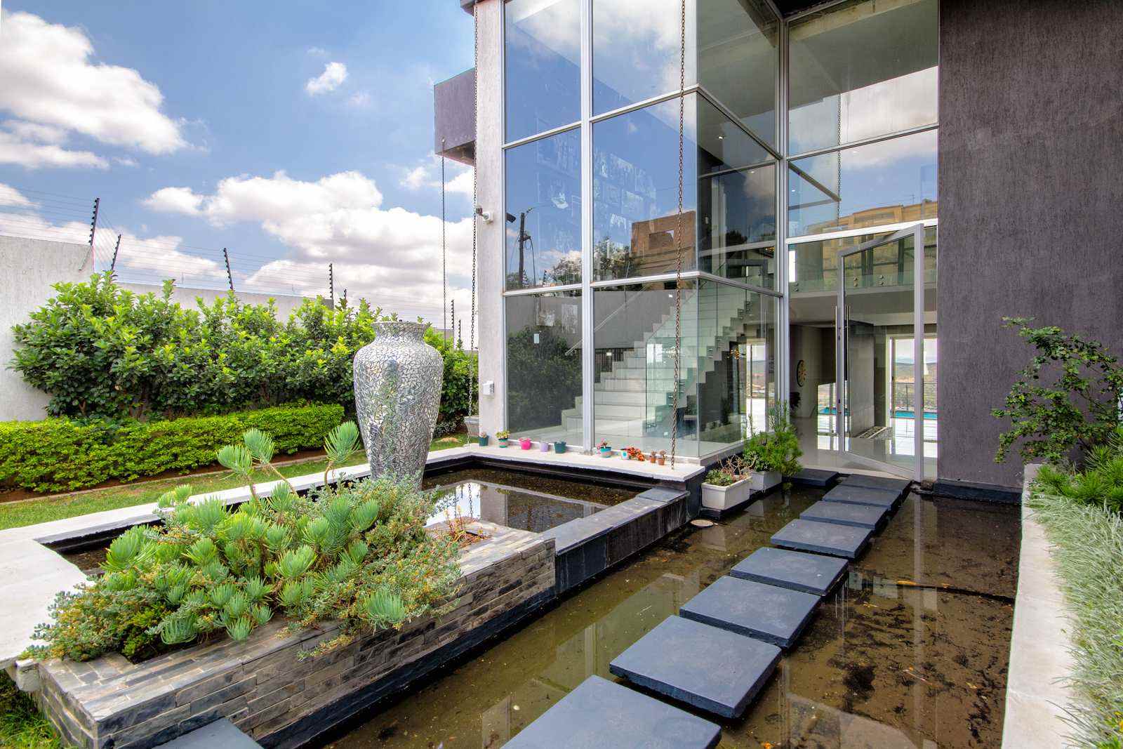 A modern West Rand home with water feature and glazed frontage